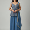 Woman wearing blue embroidered sleeveless ethnic top with matching palazzo pants and dupatta