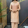 Woman wearing peach embroidered Indian ethnic wear with dupatta, standing indoors at Anandi Fashions showroom