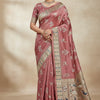 Woman wearing a dusty pink silk saree with intricate gold and multicolor floral and peacock embroidery, paired with matching blouse and traditional jewelry