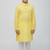 Young boy wearing a yellow textured kurta with white churidar pants, traditional Indian ethnic wear