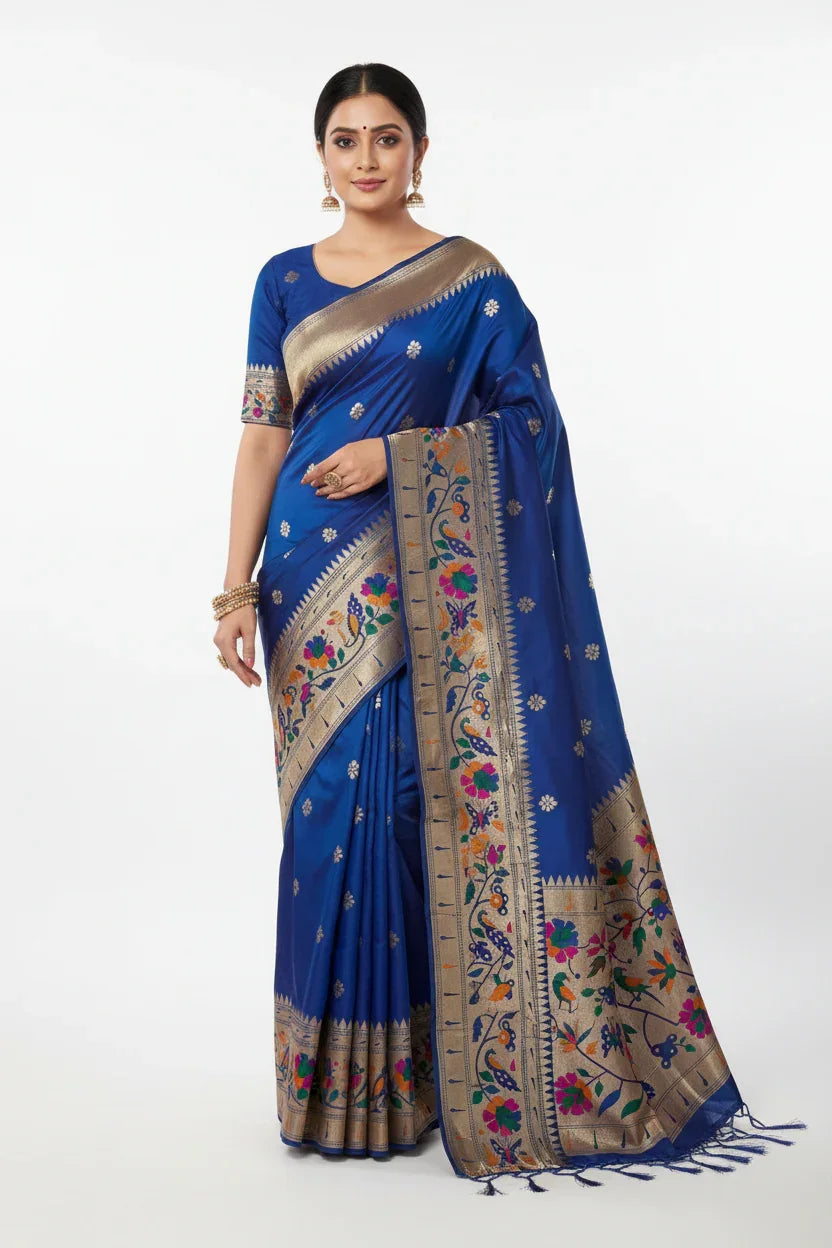 Woman wearing royal blue Indian saree with gold and multicolor floral zari embroidery and matching blouse
