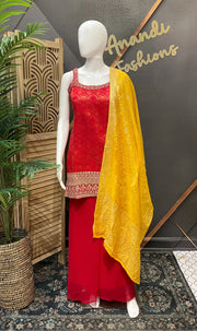 Mannequin wearing red Indian ethnic wear with gold embroidery and a yellow dupatta at Anandi Fashions boutique
