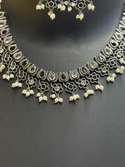 Intricate oxidized silver necklace with teardrop stones, floral motifs, and pearl clusters, Indian ethnic jewelry