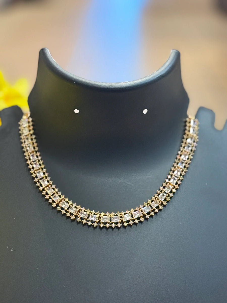 Elegant gold and diamond necklace displayed on black jewelry stand, premium Indian ethnic jewelry