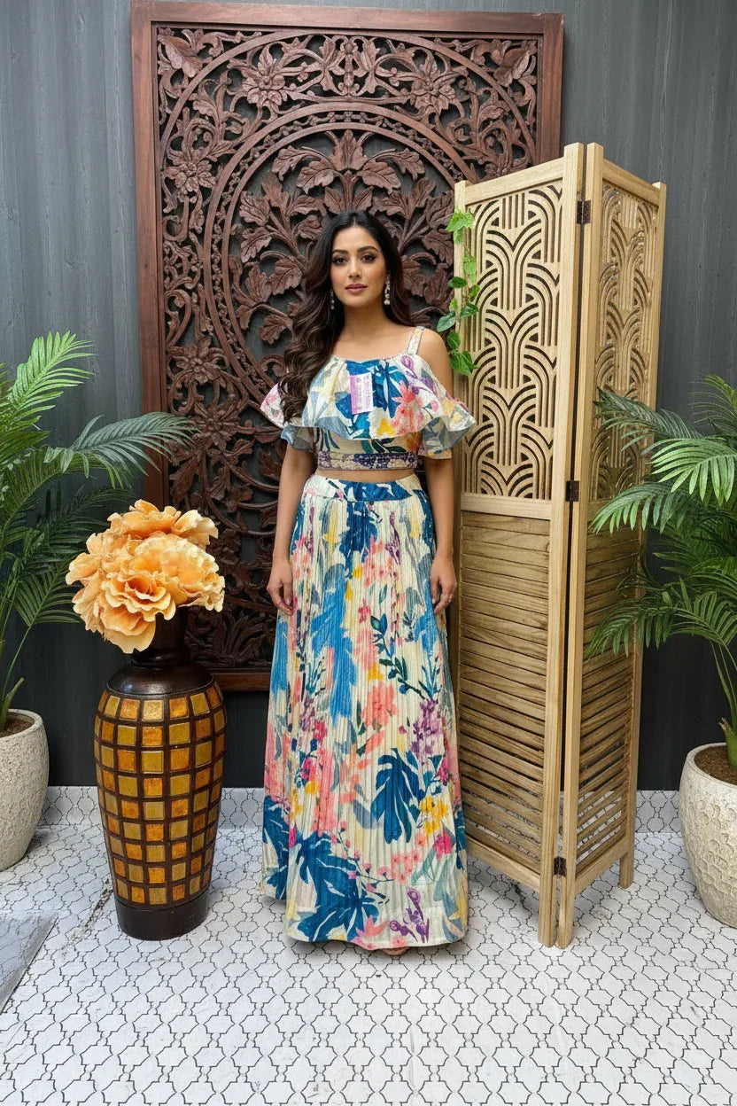 Woman in a floral dress standing in front of decorative wooden panels and plants.