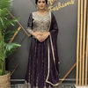 Woman modeling purple embellished lehenga choli with matching dupatta at Anandi Fashions boutique