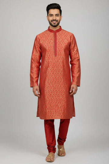 Man wearing traditional red and gold Indian ethnic kurta with churidar pants and sandals