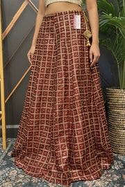 Red and gold checked Indian ethnic lehenga skirt with intricate embroidery, showcased at Anandi Fashions boutique