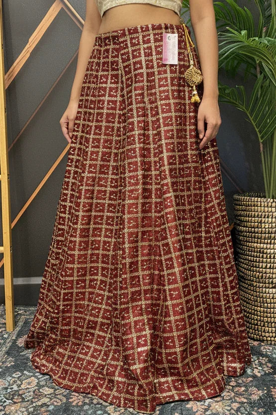 Red and gold checked Indian ethnic lehenga skirt with intricate embroidery, showcased at Anandi Fashions boutique