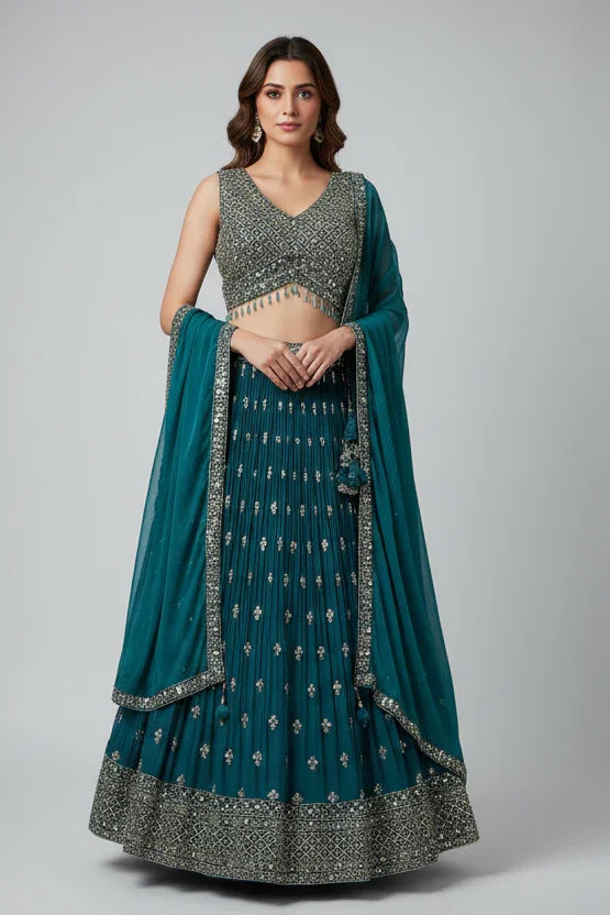 Woman wearing a teal and silver traditional outfit on a gray background