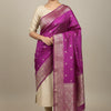 Woman wearing elegant purple and gold banarasi silk saree with cream blouse in studio at Anandi Fashions