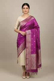 Woman wearing elegant purple and gold banarasi silk saree with cream blouse in studio at Anandi Fashions