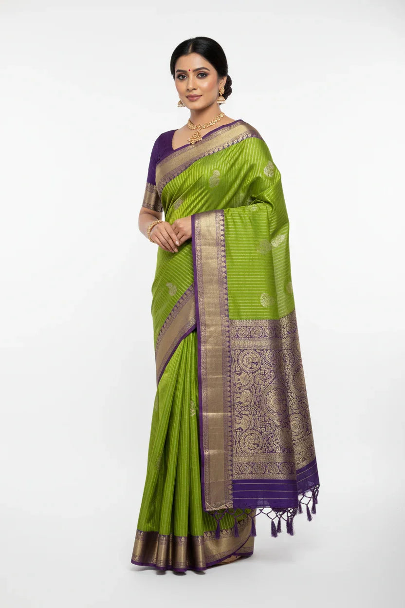 Woman wearing green and purple Banarasi silk saree with gold zari work, traditional Indian ethnic wear