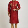 Man wearing traditional red Indian kurta with gold embroidery and beige churidar pants on plain background