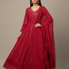 Woman wearing elegant red Indian ethnic Anarkali suit with intricate embroidery and matching dupatta
