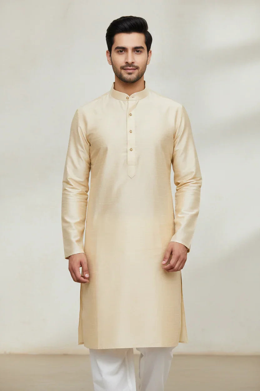 Man wearing a cream-colored silk kurta with white churidar pants, traditional Indian ethnic wear