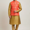Man wearing golden silk kurta pajama with a coral orange floral Nehru jacket, ethnic Indian attire from Anandi Fashions