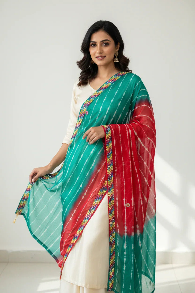 Woman in white kurta wearing green and red tie-dye dupatta with floral border, showcasing ethnic Indian fashion