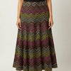 Woman wearing a vibrant multicolored zigzag patterned ethnic maxi skirt with black sleeveless top and black heels