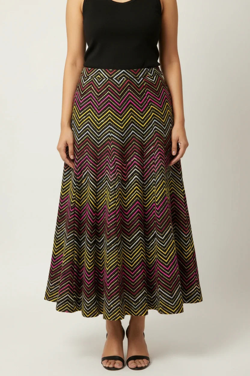 Woman wearing a vibrant multicolored zigzag patterned ethnic maxi skirt with black sleeveless top and black heels