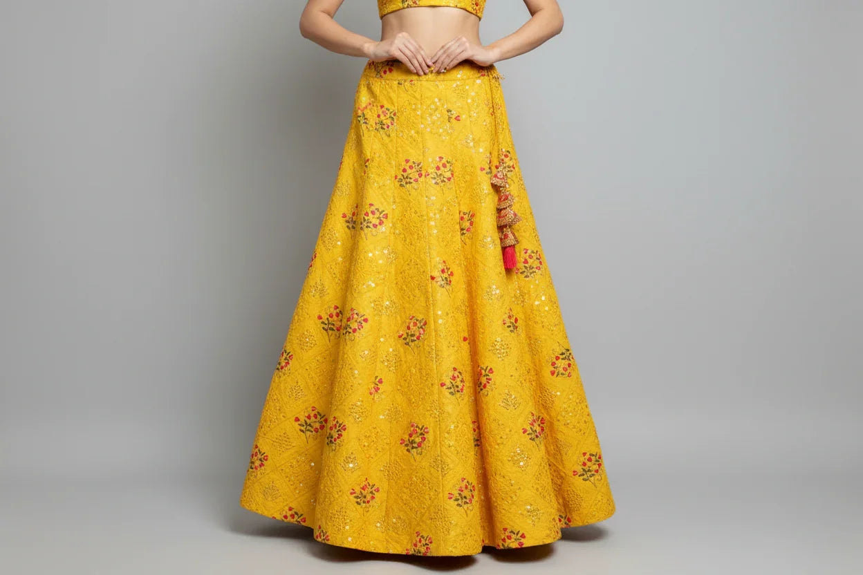 Yellow Indian ethnic lehenga skirt with red floral embroidery and sequin details from Anandi Fashions