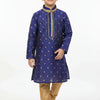 Boy in blue embroidered kurta with gold churidar pants and traditional Indian footwear on white background