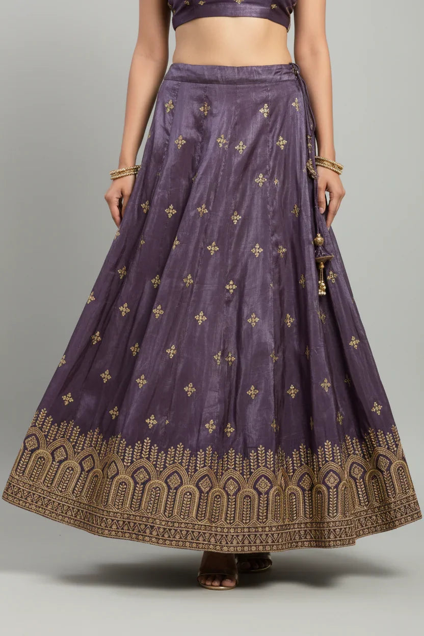 Purple Indian ethnic lehenga skirt with golden floral motifs and intricate border embroidery