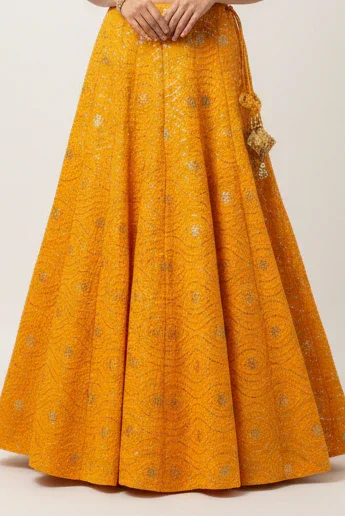 Yellow embroidered Indian ethnic lehenga skirt with gold motifs and decorative tassels