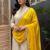 Woman wearing elegant cream and gold embroidered Indian ethnic dress with bright yellow embroidered dupatta at Anandi Fashions