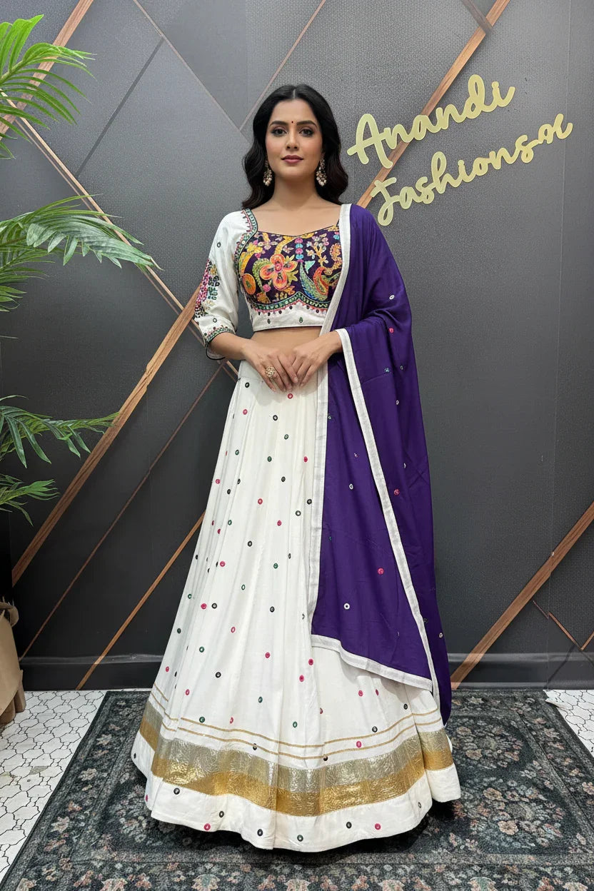 Woman in colorful floral embroidered blouse and white ethnic lehenga with gold border and purple dupatta at Anandi Fashions