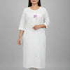 Woman wearing white Indian ethnic kurti with subtle patterns and three-quarter sleeves at Anandi Fashions