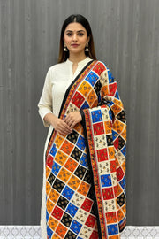 Woman wearing cream kurta and multicolored patchwork printed shawl with traditional Indian motifs