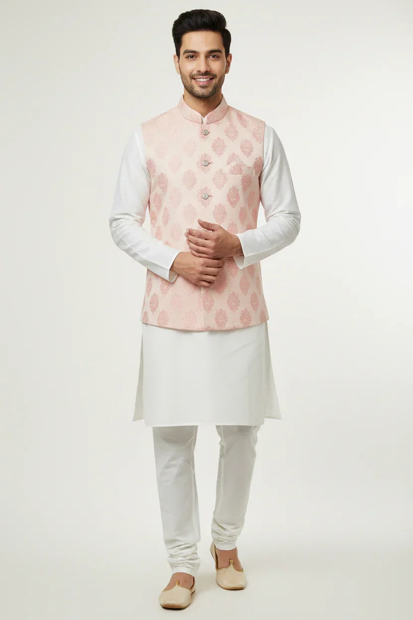 Smiling man in white kurta pajama and light pink floral patterned Nehru jacket, Indian ethnic wear
