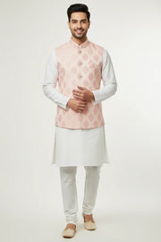 Smiling man in white kurta pajama and light pink floral patterned Nehru jacket, Indian ethnic wear