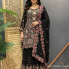 Woman modeling black Indian ethnic wear with intricate pink and gold embroidery at Anandi Fashions