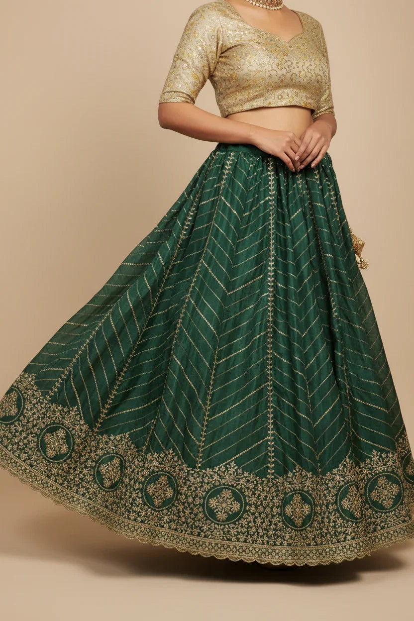 Indian ethnic lehenga with gold embroidered green skirt and gold brocade blouse on model