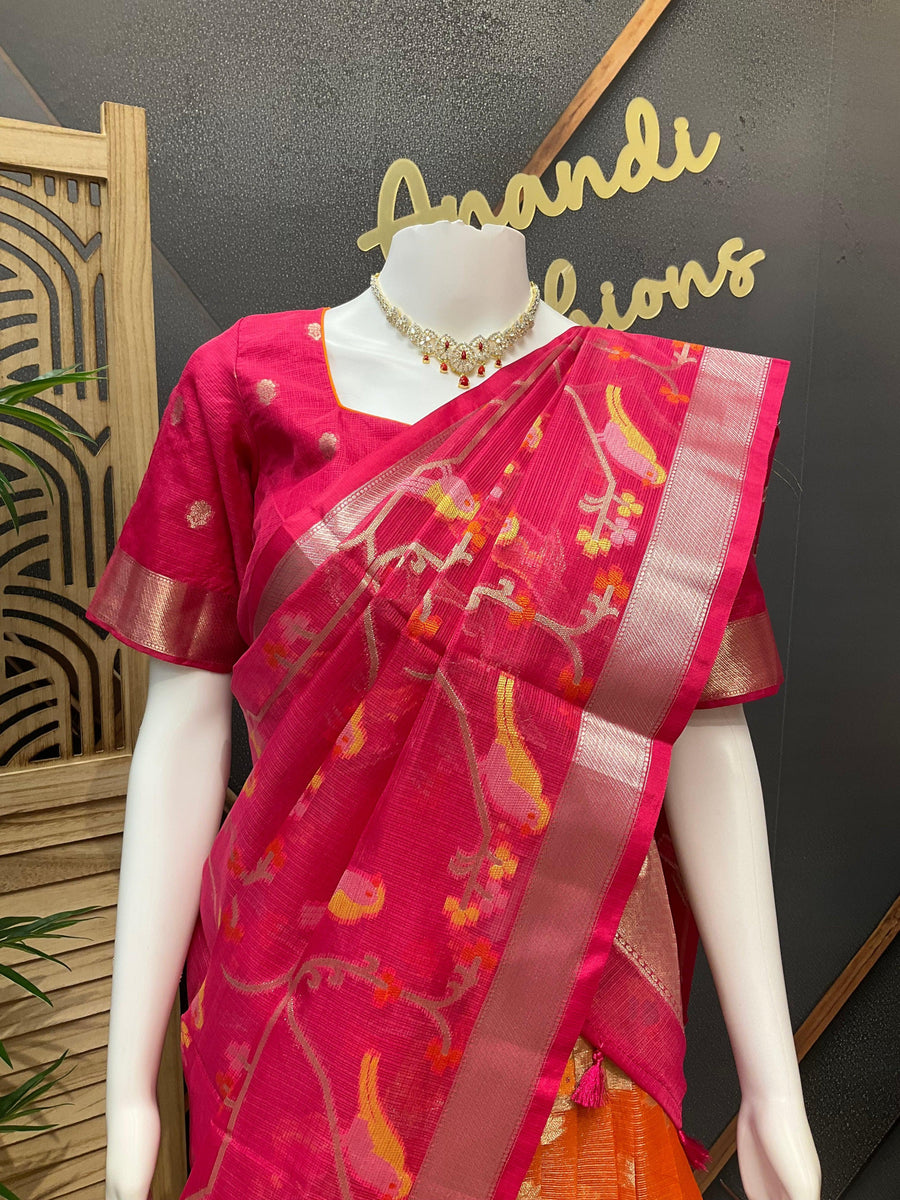 Pink Indian saree with floral and bird motifs on a mannequin, paired with gold-tone blouse and necklace at Anandi Fashions