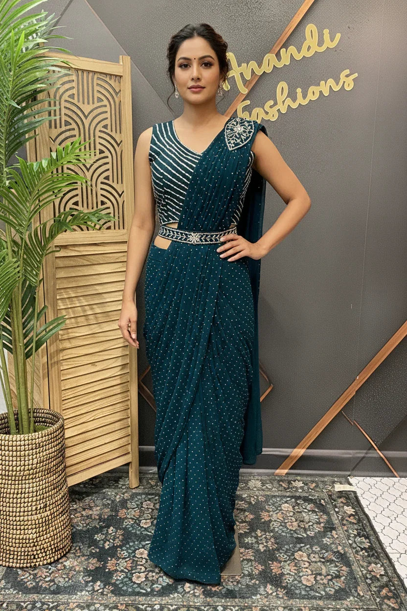 Woman wearing elegant teal Indian saree with silver embellishments at Anandi Fashions boutique