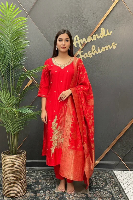 Woman in red embroidered Indian ethnic wear with matching dupatta posing indoors at Anandi Fashions boutique