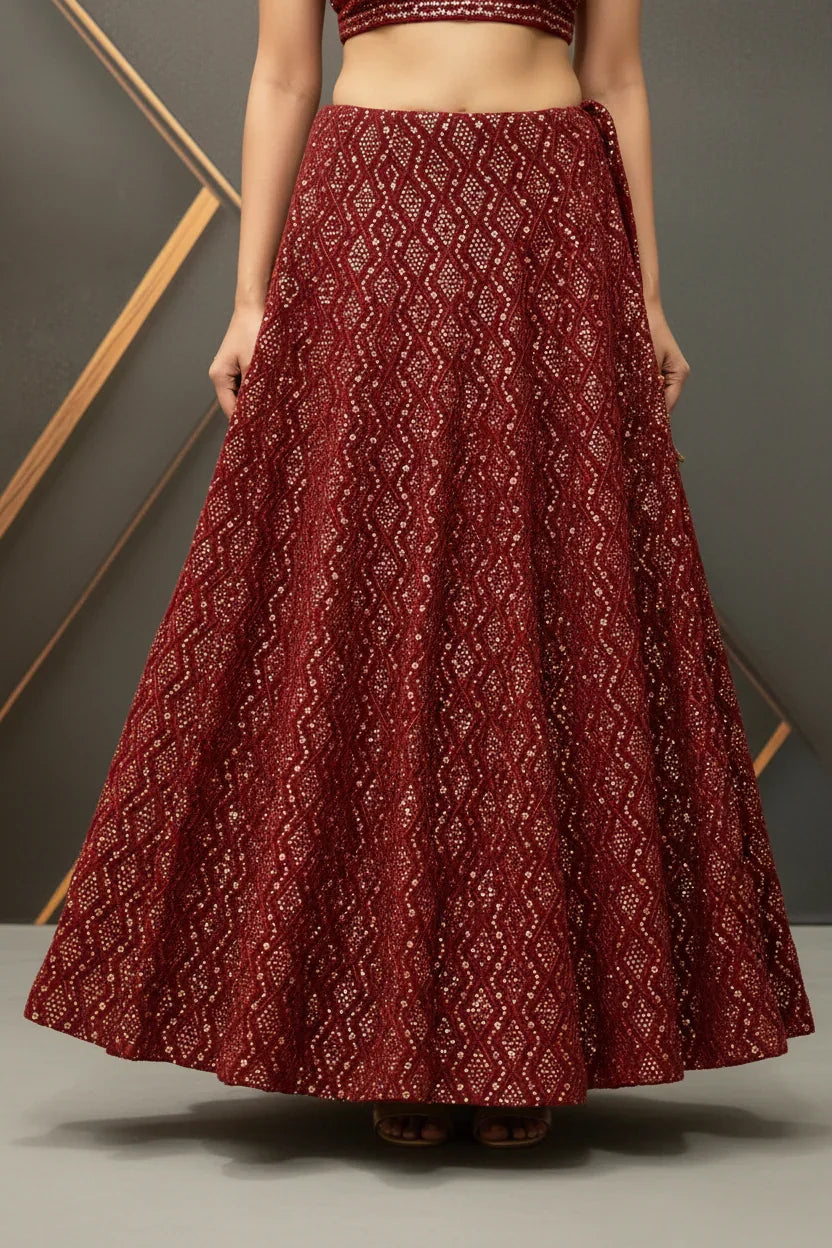 Maroon Indian ethnic lehenga skirt with intricate sequined zigzag pattern, worn by woman in studio