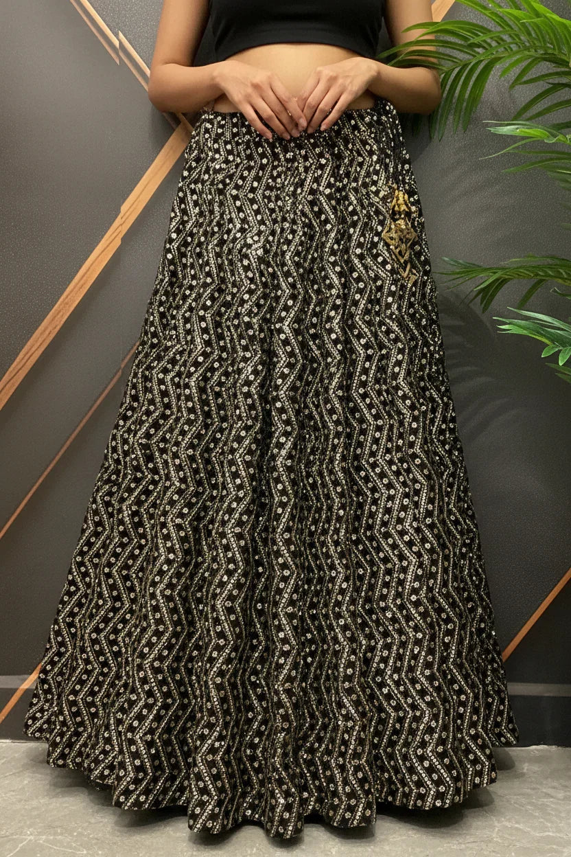 Black and gold embroidered Indian ethnic skirt with zigzag patterns worn by a model at Anandi Fashions
