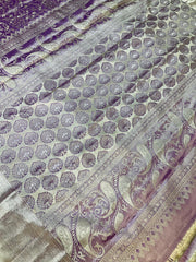 Close-up of purple and gold Indian saree with intricate floral and paisley brocade patterns