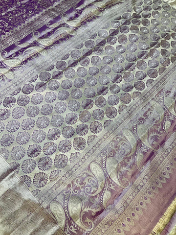 Close-up of purple and gold Indian saree with intricate floral and paisley brocade patterns