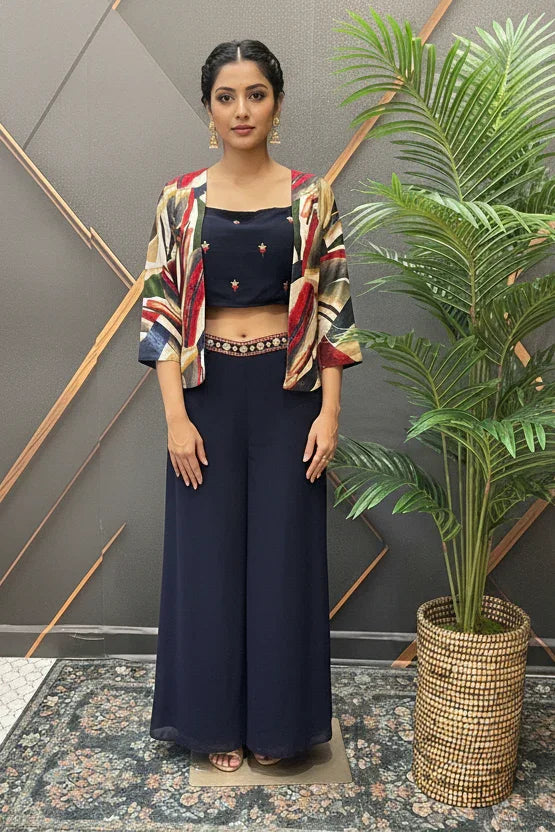 Woman in stylish Indian ethnic outfit with navy crop top, printed jacket, and palazzo pants at Anandi Fashions