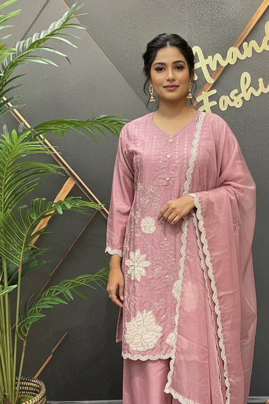 Woman in pink Indian ethnic wear with white floral embroidery and matching dupatta at Anandi Fashions