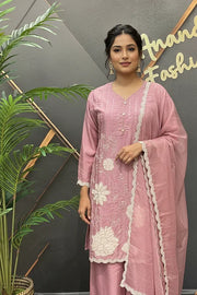 Woman in pink Indian ethnic wear with white floral embroidery and matching dupatta at Anandi Fashions