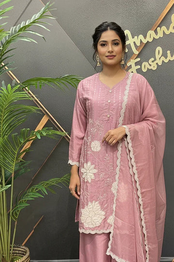 Woman in pink Indian ethnic wear with white floral embroidery and matching dupatta at Anandi Fashions