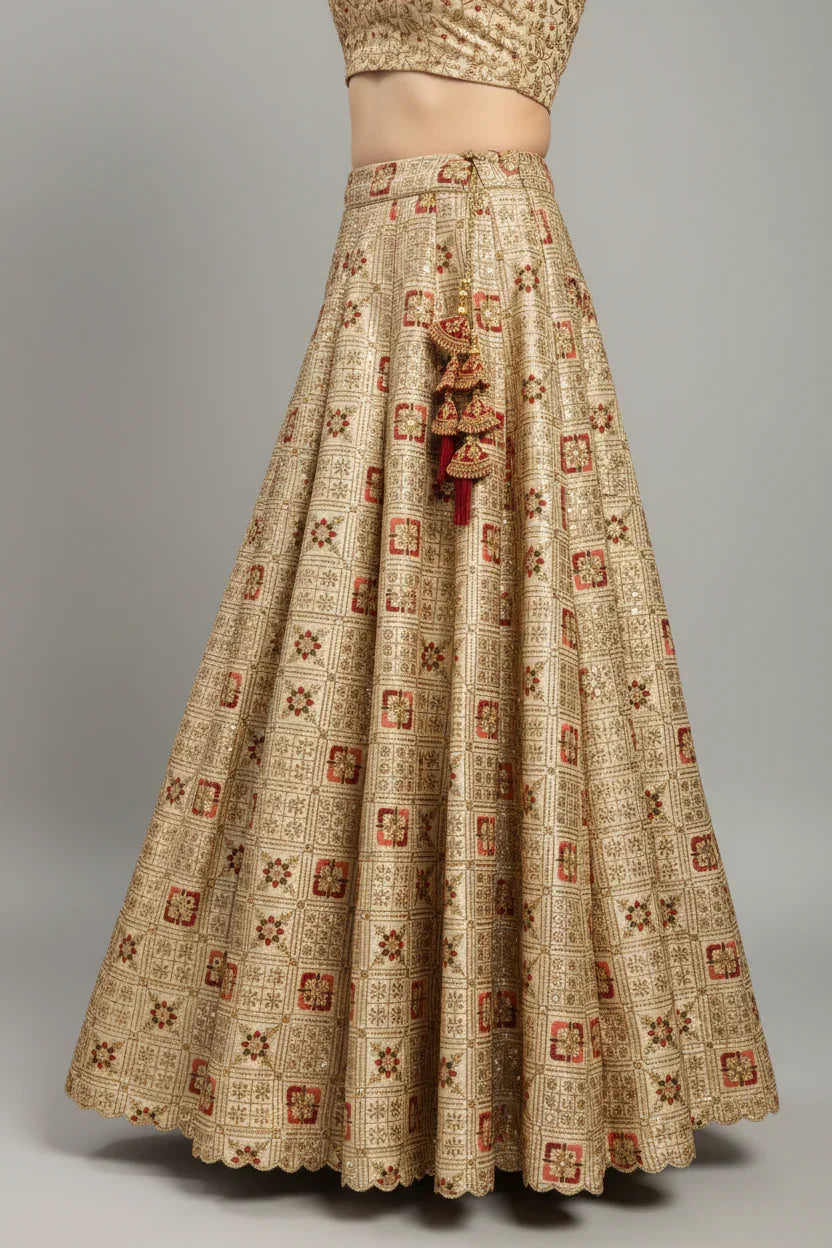 Gold embroidered Indian ethnic lehenga skirt with red floral motifs and tassel detailing