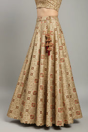 Gold embroidered Indian ethnic lehenga skirt with red floral motifs and tassel detailing