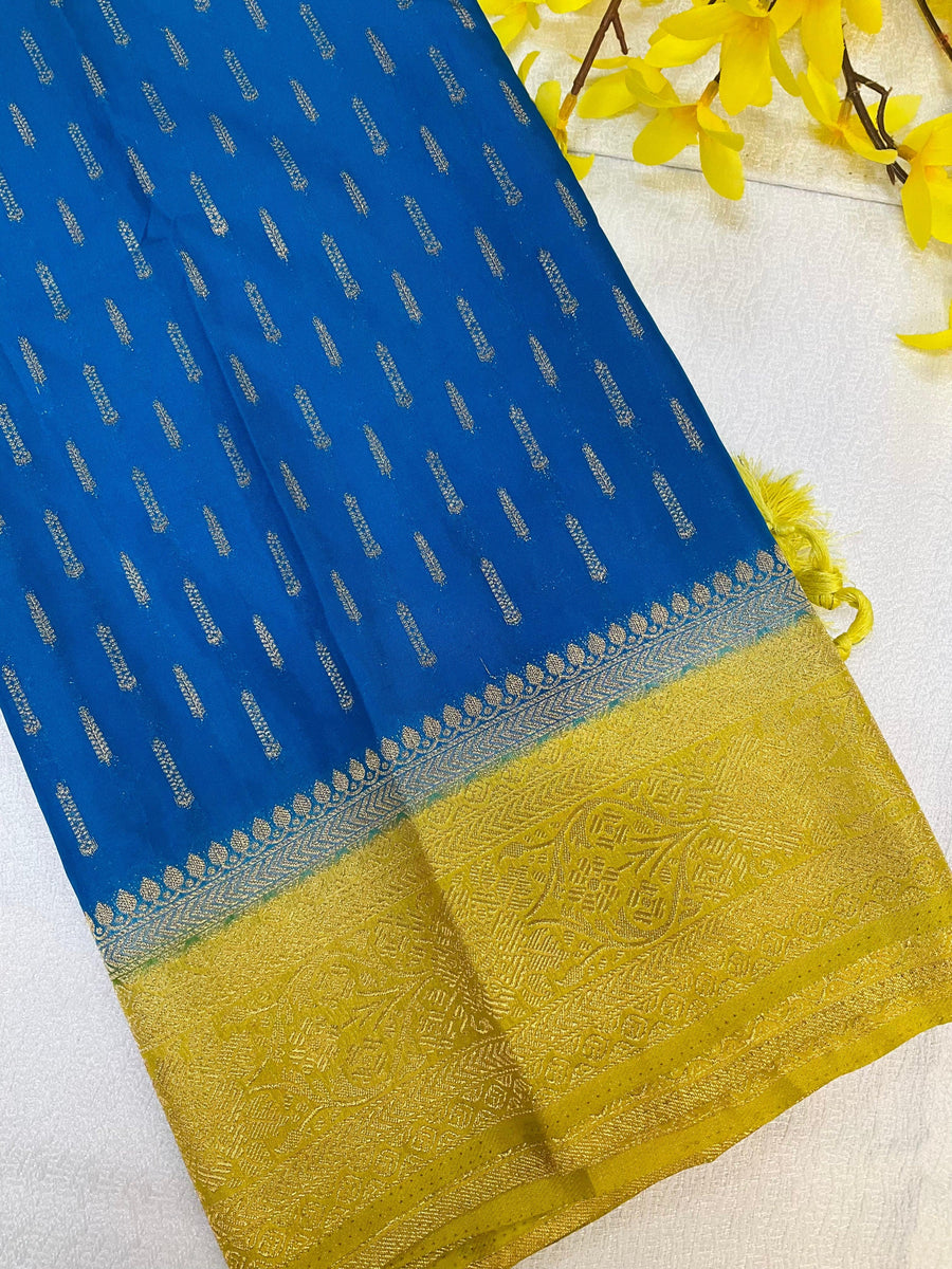 Blue Indian ethnic fabric with golden woven patterns and detailed golden border with tassels